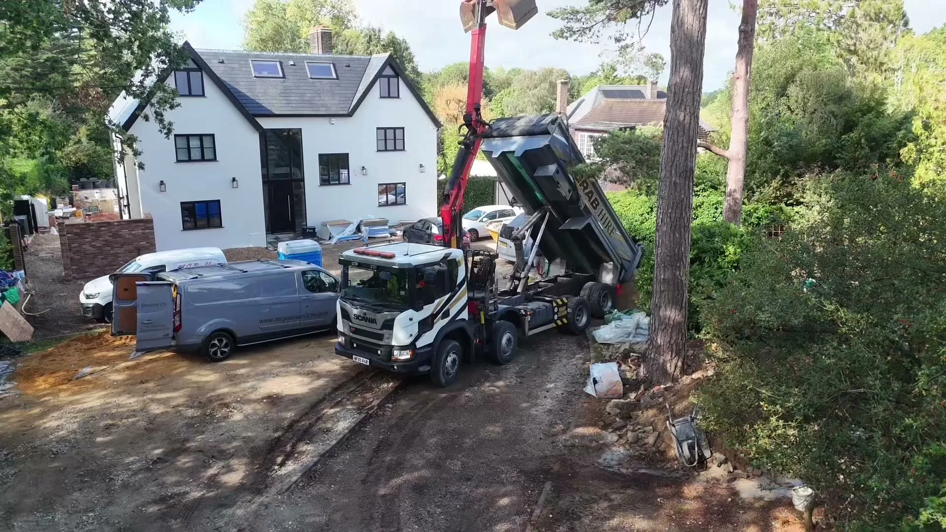 Grab lorry delivering topsoil to a house in Croydon